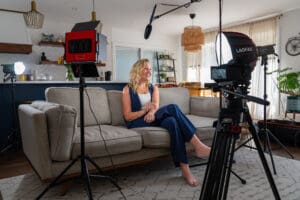 a woman sitting on a couch for a legacy video life story to preserve family history